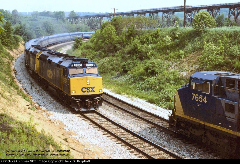 CSX 9992, with eastbound 892-04 meets, and passes CSX Q137 with CSX 7654 leading at Salisbury Jct, Pennsylvania. June 5, 2002.  